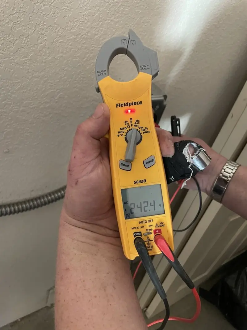 Voltage testing with clamp meter during Outlet Installation in Concordia